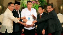 Philippine President Rodrigo Duterte (C) with Moro Islamic Liberation Front (MILF) chairperson Al Haj Murad Ebrahim (2nd from L), Jesus Dureza, Secretary of Peace Process, Ghazali Jaafar (2nd from R), MILF vice-chairman and Mohagher Iqbal, MILF peace panel chairman, hold a draft law of the Bangsamoro Basic Law (BBL) during a ceremony at the Malacanang presidential palace in metro Manila, Philippines July 17, 2017. REUTERS/Romeo Ranoco