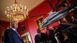 President Donald Trump looks at Sikorsky helicopters miniature models. "Your drivers are very good," Trump said to a representative of Ping, the Arizona-based maker of golf clubs, noting that he had golfed with British pro golfer Lee Westwood, who is a fan. He discussed sales of Sikorsky helicopters - "I have three of them!" he said, lifted horseshoes made with Nucor Corp steel, and strolled past vacuum-sealed Omaha steaks.