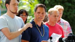 Don Damond is comforted by his son Zach Damond as he speaks to the media about his fiance, Justine Damond who was fatally shot by Minneapolis police in Minneapolis, Minnesota. REUTERS/Adam Bettcher