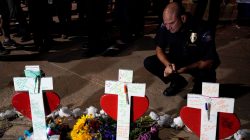 Lt. Jad Lanigan of the Aurora police department looks over crosses for those killed in the Aurora theater shooting, at a vigil on the 5-year anniversary of the tragedy in Aurora, Colorado July 20, 2017. REUTERS/Rick Wilking