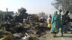 People walk at the site after a bombing attack of an internally displaced persons camp in Rann, Nigeria January 17, 2017. MSF/Handout via Reuters