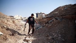 A fighter from Free Syrian Army's Al Rahman legion walks near piled sandbags in Ain Tarma, eastern Damascus suburb of Ghouta, Syria July 17, 2017. REUTERS/Bassam Khabieh
