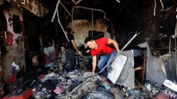 An Afghan shopkeeper inspects his shop after a suicide attack in Kabul, Afghanistan July 24, 2017.