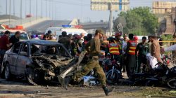 Rescue workers and policemen gather after a suicide blast in Lahore, Pakistan July 24, 2017.