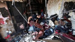 An Afghan shopkeeper inspects his shop after a suicide attack in Kabul, Afghanistan July 24, 2017. REUTERS/Mohammad Ismail