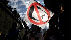 Opposition supporters carry a flag with a cartoon of Venezuela's President Nicolas Maduro while attending a rally to pay tribute to victims of violence during protests against Maduro's government in Caracas, Venezuela. REUTERS/Ueslei Marcelino