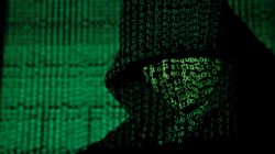 A projection of cyber code on a hooded man is pictured in this illustration picture taken on May 13, 2017. REUTERS/Kacper Pempel/Illustration