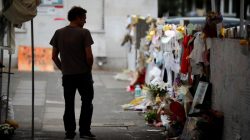 A man looks at floral tributes for the victims of the Grenfell Tower fatal fire, in London, Britain July 15, 2017. REUTERS/Tolga Akmen