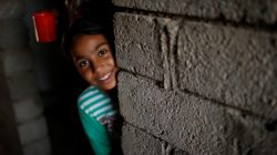 Nine-year-old Iraqi girl Meriam looks out as she stands inside a house, east of Mosul, Iraq July 28, 2017.