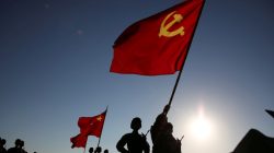 Soldiers carry a PLA flag and Chinese national flags before the military parade to commemorate the 90th anniversary of the foundation of China's People's Liberation Army (PLA) at Zhurihe military base in Inner Mongolia Autonomous Region, China, July 30, 2017. REUTERS/Stringer