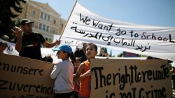 Syrian refugee children hold banners and shout during a demonstration against delays in reunifications of refugee families from Greece to Germany, in Athens, Greece, August 2, 2017. REUTERS/Alkis Konstantinidis