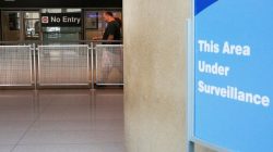 FILE PHOTO: A sign warns of surveillance at the International Arrival area, on the day that U.S. President Donald Trump's limited travel ban, approved by the U.S. Supreme Court, goes into effect, at Logan Airport in Boston, Massachusetts, U.S., June 29, 2017. REUTERS/Brian Snyder