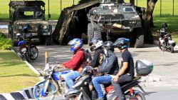 Motorists drive past an Armoured Personnel Carrier (APC) parked near the venue of the 50th ASEAN Foreign Ministers meeting in Pasay city, metro Manila, Philippines August 4, 2017.