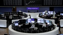 Traders work in front of the German share price index, DAX board, at the stock exchange in Frankfurt, Germany, August 4, 2017.
