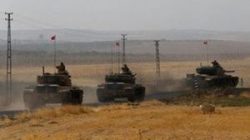 : Turkish army tanks drive towards to the border in Karkamis on the Turkish-Syrian border in the southeastern Gaziantep province, Turkey, August 25,