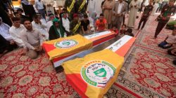 Mourners pray near the coffins of Iraqi Shi'te fighters known as Kattaib Sayeed al-Shuhadaa, who were killed near the Syrian border, during the funeral in Najaf, Iraq August 8, 2017. REUTERS/Alaa Al-Marjani