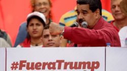 Venezuela's President Nicolas Maduro stands next to a sign that reads "Trump go away from Latin America" gives a speech at a rally against U.S President Donald Trump in Caracas, Venezuela August 14, 2017. REUTERS/Ueslei Marcelino