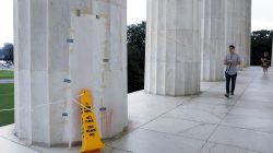 Tourists walks past a papered-over column where a vandal scrawled obscene graffiti in spray paint on the Lincoln Memorial in Washington, U.S. August 15, 2017. REUTERS/Jonathan Ernst