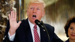 U.S. President Donald Trump speaks about the violence, injuries and deaths at the "Unite the Right" rally in Charlottesville as he talks to the media with Secretary of Transportation Elaine Chao (R) at his side in the lobby of Trump Tower in Manhattan, New York, U.S., August 15, 2017. REUTERS/Kevin Lamarque