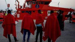 Migrants, who are part of a group intercepted aboard a dinghy off the coast in the Mediterranean sea, stand after arriving on a rescue boat at a port in Malaga, Spain August 7, 2017. REUTERS/Jon Nazca