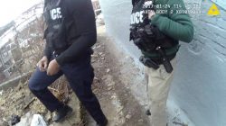 A still image captured from police body camera video appears to show two Baltimore police officers look on as a colleague places a small plastic bag in a trash-strewn yard (not shown) according to the Maryland Office of the Public Defender in this image released in Baltimore, Maryland, U.S. on July 19, 2017. Courtesy Baltimore Police Department/Handout via REUTERS ATTENTION EDITORS - THIS IMAGE WAS PROVIDED BY A THIRD PARTY. - RTX3C930