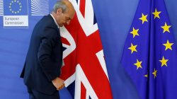 FILE PHOTO: A worker arranges flags at the EU headquarters as Britain and the EU launch Brexit talks in Brussels, June 19, 2017. REUTERS/Francois Lenoir/File Photo