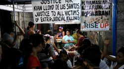 Neighbours play cards at the wake of Kian delos Santos, a 17-year-old student who was shot during anti-drug operations in Caloocan, Metro Manila, Philippines August 22, 2017. REUTERS/Dondi Tawatao