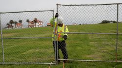 A worker installs a fence at Crissy Field in anticipation of Saturday's Patriot Prayer rally and counter demonstration in San Francisco, California, U.S. August 25, 2017. REUTERS/Stephen Lam