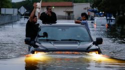 Residents use a truck to navigate through flood waters from Tropical Storm Harvey in Houston, Texas, U.S. August 27, 2017.
