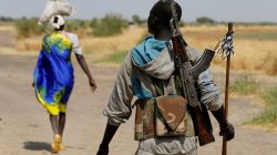 FILE PHOTO: An armed man walks on a path close to the village of Nialdhiu, South Sudan February 7, 2017. REUTERS/Siegfried Modola/File Photo