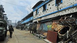 Government troops walks past damaged buildings and houses after 100 days of intense fighting between soldiers and insurgents from the Maute group, who have taken over parts of Marawi city, southern Philippines August 30, 2017. REUTERS/Froilan Gallardo