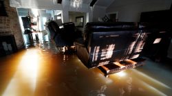 A family puts their belongings on furniture to keep them above floodwaters in their house from Harvey in Houston, Texas August 31, 2017
