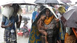Rohingya refugees stands in an open place during heavy rain, as they are hold by Border Guard Bangladesh (BGB) after illegally crossing the border, in Teknaf, Bangladesh, August 31, 2017.