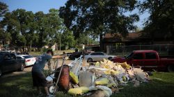 Lorenzo Salina helps a neighbor to clean a house damaged by Tropical Storm Harvey in East Houston, Texas, U.S. September 1, 2017.