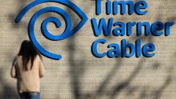 A woman walks in front of the Time Warner Cable logo at its office in San Diego, California, U.S., November 2, 2016. REUTERS/Mike Blake
