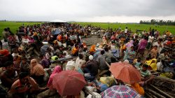 Rohingya refugees sit as they are temporarily held by the Border Guard Bangladesh (BGB) in an open area after crossing the border, in Teknaf, Bangladesh, September 3, 2017.