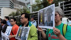 FILE PHOTO: Pro-democracy demonstrators hold up portraits of Chinese disbarred lawyer Jiang Tianyong, demanding his release, during a demonstration outside the Chinese liaison office in Hong Kong, China December 23, 2016. REUTERS/Tyrone Siu