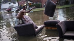 Vince Ware moves his sofas onto the sidewalk from his house which was left flooded from Tropical Storm Harvey in Houston, Texas. REUTERS/Adrees Latif