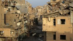 FILE PHOTO: A view shows damaged buildings in Deir al-Zor, eastern Syria February 19, 2014. REUTERS/Khalil Ashawi/File Photo