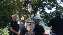 Police officers stand around a statue of Confederate general Thomas J. "Stonewall" Jackson during a Black Lives Matter rally in Charleston, West Virginia, U.S., August 20, 2017. REUTERS/Marcus Constantino