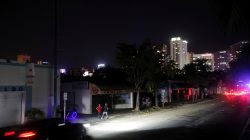 Local residents stand in the darkness as many areas of Miami still without electricity after Hurricane Irma strikes Florida, in Little Havana, Miami, Florida, September 11, 2017. REUTERS/Carlos Barria