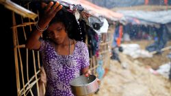 A Rohingya refugee girl collects rain water at a makeshift camp in Cox's Bazar, Bangladesh, September 17, 2017. REUTERS/Mohammad Ponir Hossain