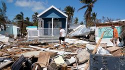 Residents walk though a debris field of former houses following Hurricane Irma in Islamorada, Florida, U.S., September 15, 2017. REUTERS/Carlo Allegri