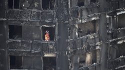 FILE PHOTO: A member of the emergency services works inside the Grenfell apartment tower block in North Kensington, London, Britain June 17, 2017. REUTERS/Hannah McKay/File Photo