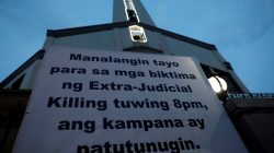 A sign is posted outside a Catholic church which translates to "Let us pray for the victims of extrajudicial killings, bells will toll at 8:00pm" in Quezon City, metro Manila, Philippines September 22, 2017. REUTERS/Dondi Tawatao