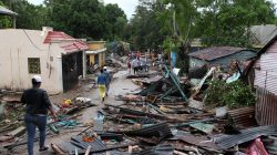 Locals walk by a street affected by an overflow of the Soco River in El Seibo, Dominican Republic, September 22, 2017. REUTERS/Ricardo Rojas