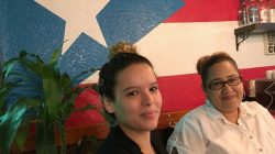 Evelyn Carrillo, 24, (L) and Deserie Rivera, 34, pose for a photo at Café Borinquen, the Puerto Rican restaurant where they work in Plantation, Florida, U.S., September 21, 2017. Photo taken September 21, 2017. REUTERS/Bernie Woodall