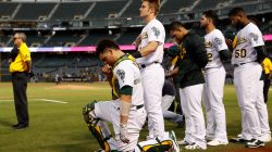 Bruce Maxwell of the Oakland Athletics kneels during the singing of the National Anthem before his MLB American League baseball game against the Seattle Mariners at Oakland-Alameda County Coliseum in Oakland, California, U.S., September 25, 2017. REUTERS/Stephen Lam