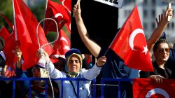Supporters of President Tayyip Erdogan wave Turkish flags during a trial for soldiers accused of attempting to assassinate the president on the night of the failed last year's July 15 coup, in Mugla, Turkey, October 4, 2017. REUTERS/Osman Orsal