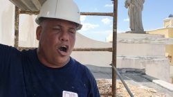 Jesus Santos sings operatic love songs while repairing plaster to a Hurricane Maria damaged facade at Cathedral of San Juan Bautista in San Juan, Puerto Rico on October 4, 2017. Picture taken on October 4, 2017. REUTERS/Hugh Bronstein